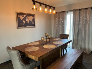 Dining Area ~ Gorgeous wood dining table, bench seats, and two chairs.