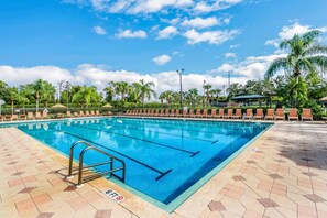 The community pool and sundeck, surrounded by lounge chairs, outdoor tables & umbrellas is the perfect spot to enjoy the Florida sunshine.