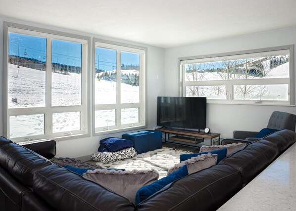 Living room with plenty of seating and spectacular slope-facing views