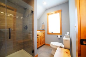 The recently renovated bathroom enjoys a large walk-in shower and a cozy vanity.