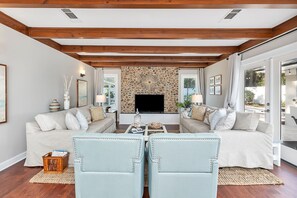 Wooden beams and a stone fireplace
in the inviting Living Room