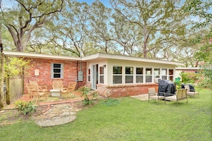 Back Patio – Private Yard on Jekyll Island - Grill under the oaks—this backyard at Mocama offers the kind of Jekyll Island peace you can’t book by the hour.