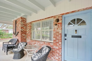 Front Porch – Blue Door & Brick at Mocama - Start your mornings with coffee and sea air on this classic Jekyll Island front porch—anchored (literally) by coastal charm and that signature blue door.
