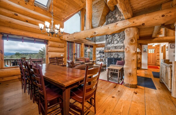 Dining area with room for 12 people and large fireplace in background