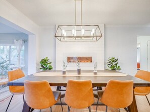 Dining table easily accommodates 8! Seamlessly change the color of the fireplace to set the mood
