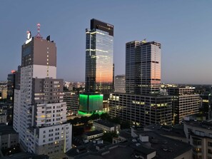 City skyline at night with illuminated skyscrapers and a modern urban view.

