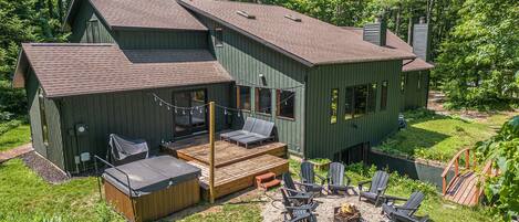 Back deck, hot tub and fire pit overlooking the pond, and a large charcoal grill....what more could you want??