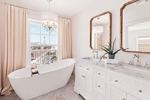 Relax and soak in the master bathroom slipper tub with a view of the water!
