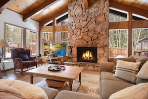 Open living space with fireplace, Smart TV, and deck access