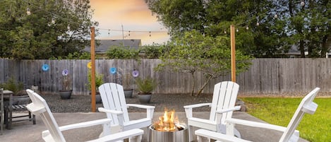 Relax on the extra large back patio with a Solo Stove fire pit and string lights