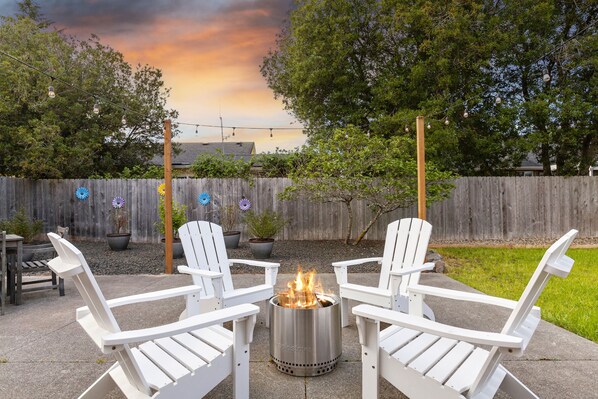 Relax on the extra large back patio with a Solo Stove fire pit and string lights