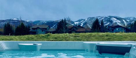 Hot tub with view of golf course & mountains