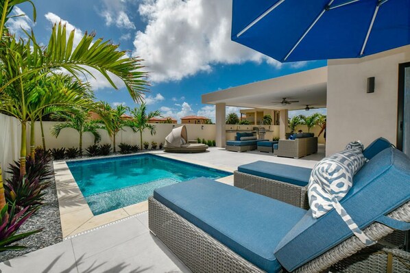 Private backyard with pool, kitchenette (incl. BBQ), lounging & dining areas