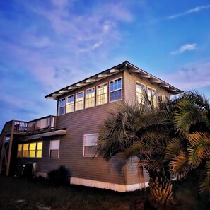 Tarpon Point Beach House Evening view of side of house 