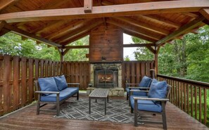 Welcoming entrance with outdoor seating and wood-burning fireplace