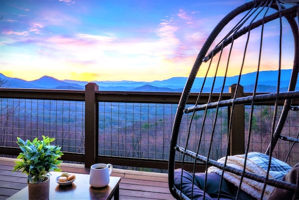 Breathe in the sweeping AMAZING mountain views that goes for miles as you unwind on the upper master bedroom’s private deck, nestled in the egg chair with your favorite drink. This is the private deck from the upper master.