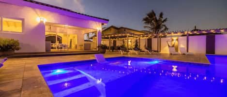 Captivating view of the pool area with pool lighting at night.