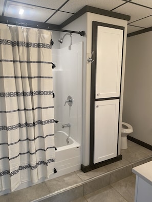 Full size tub and shower with large vanity and pantry.