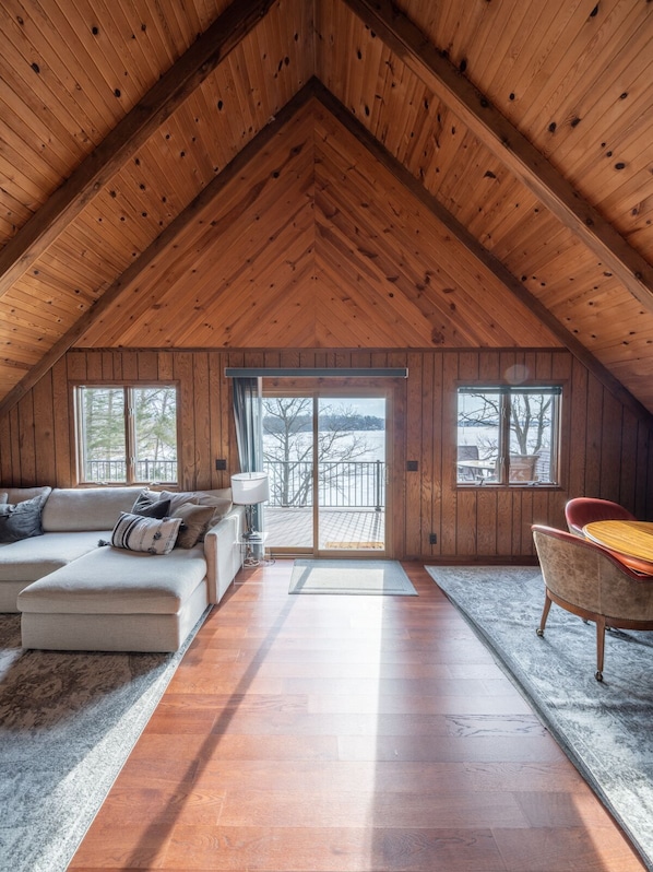 The A-frame highlights the expansive lake views from the back of the cabin.