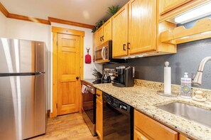 Fully equipped kitchen with brand new refrigerator and Kuerig coffee machine.