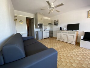 Living room with sofa bed and kitchen