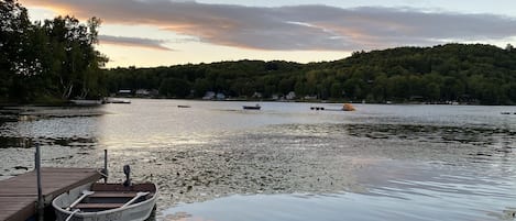 Dock, boat, and lakefront at sunset