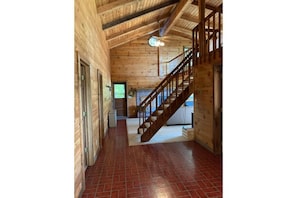 View of front door and stairs to loft