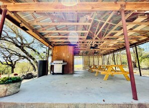 Covered patio with BBQ and picnic tables