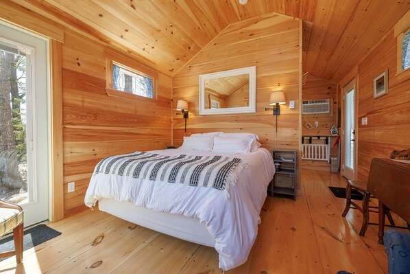 The inviting queen-size bed is dressed in soft, high-quality linens