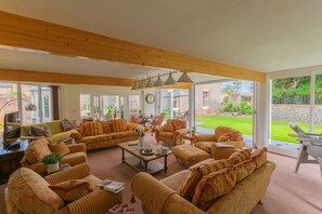 The Garden Room with comfortable seating for 12 guests. Opens onto the gardens.