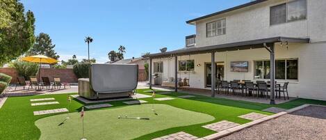 No shortage of backyard entertainment with the above ground four-person spa, private putting green and bocce ball court