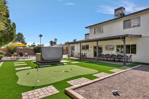 No shortage of backyard entertainment with the above ground four-person spa, private putting green and bocce ball court