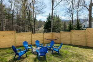 Outdoor entertainment area with a fire pit and hammocks. There is also a downstairs area of the home accessed from here that has a full bathroom, kids area, and mini-fridg so that you can enjoy your time without running back and forth into the home. 