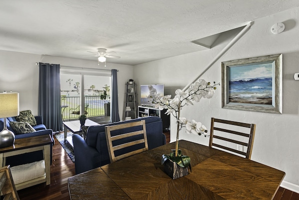 comfortable living and dining area  with large balcony and partial ocean view
