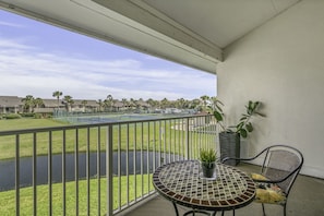 Relaxing view of the fountain and tennis courts and partial ocean view .