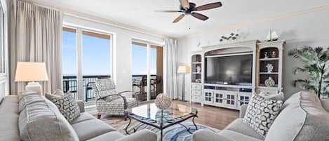 Oceanfront living room with balcony access.