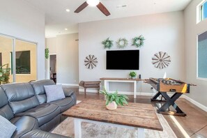Step into this inviting living room, where a spacious sectional and flat-screen TV await your enjoyment.