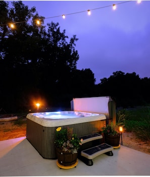 Hot tub at night w/ solar lights above. The colors can shift to match your mood!
