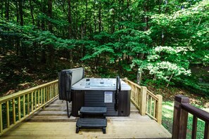 Unwind in our private hot tub, surrounded by Vermont's lush forest.
