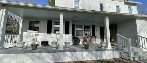 Renovated 7 bedroom farmhouse with front porch for rocking away the day. 
