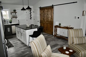 Main living area - washer/dryer & pantry behind barn door