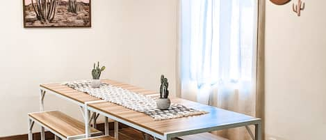 Dining table in kitchen with bench seating for 8 guests