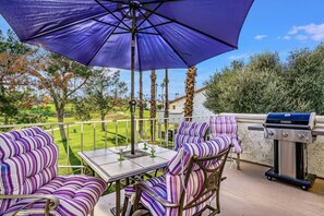 Private balcony with barbeque and dining area, golf course & mountain views.