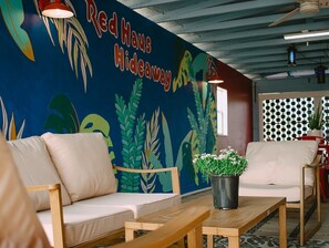 Enjoy the outdoor covered lounge; equipped with dining area and  70' TV