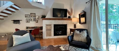 Bright living-room with fireplace & vaulted ceilings.