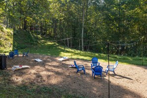 Large yard with games, lighting, and seating.