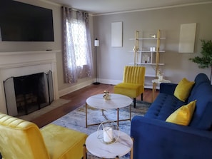 Living room with view of fireplace and 50 in Smart Tv