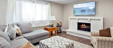 Living Room has TV, wood burning Fireplace and comfortable seating, a Perfect Place to Gather as Family or Friends