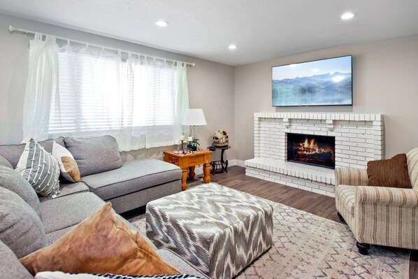 Living Room has TV, wood burning Fireplace and comfortable seating, a Perfect Place to Gather as Family or Friends
