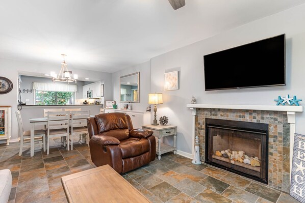 Living room - Living area with faux fireplace and open to dining area.